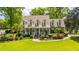Beautiful home showcasing a well-manicured lawn, charming porch, and vibrant landscaping at 4403 Wild Thicket Ln, North Charleston, SC 29420