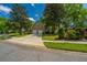 Home featuring a two-car garage, mature trees, and manicured lawn for a welcoming look in a suburban neighborhood at 4403 Wild Thicket Ln, North Charleston, SC 29420