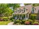 Inviting two-story home with a charming front porch and vibrant, well-maintained landscaping at 4403 Wild Thicket Ln, North Charleston, SC 29420
