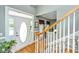 Bright foyer featuring hardwood floors, staircase, and a welcoming front door at 4403 Wild Thicket Ln, North Charleston, SC 29420