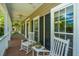 Inviting front porch features rocking chairs and views of the lovely neighborhood at 4403 Wild Thicket Ln, North Charleston, SC 29420