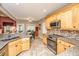 Well-equipped kitchen featuring granite countertops, stainless steel appliances, and wood cabinets at 4403 Wild Thicket Ln, North Charleston, SC 29420