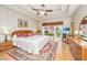 Serene primary bedroom featuring a tray ceiling, window views, and stylish decor at 4403 Wild Thicket Ln, North Charleston, SC 29420
