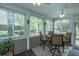 Bright sun room with multiple windows, tiled floors, ceiling fans, and a seating area to enjoy the outdoors indoors at 4403 Wild Thicket Ln, North Charleston, SC 29420
