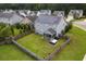 Aerial view of yard with wooden fence and a screened in porch and solar panels on roof at 504 Foxbank Plantation Blvd, Moncks Corner, SC 29461