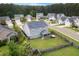 Aerial view of a fenced yard, solar panels, and a screened in porch in a Gathering neighborhood at 504 Foxbank Plantation Blvd, Moncks Corner, SC 29461