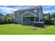 View of backyard with hot tub, lawn, and screened-in porch at 504 Foxbank Plantation Blvd, Moncks Corner, SC 29461