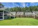 View of backyard with hot tub, lawn, trees, and neighbor's house at 504 Foxbank Plantation Blvd, Moncks Corner, SC 29461