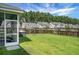 Expansive backyard featuring well-maintained lawn, wooden privacy fence, and an enclosed porch with an outside hot tub at 504 Foxbank Plantation Blvd, Moncks Corner, SC 29461