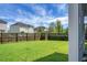 View of backyard with fence, lawn, trees, and neighbor's house at 504 Foxbank Plantation Blvd, Moncks Corner, SC 29461