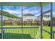 View of backyard with fence, lawn, trees, and neighbor's house at 504 Foxbank Plantation Blvd, Moncks Corner, SC 29461