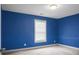 A cozy bedroom with blue walls featuring a window allowing lots of natural light at 504 Foxbank Plantation Blvd, Moncks Corner, SC 29461