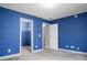 Bedroom with bold blue walls featuring two doorways and a closet with wire shelving at 504 Foxbank Plantation Blvd, Moncks Corner, SC 29461