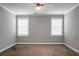 This bedroom features neutral walls and carpet, a ceiling fan, and lots of natural light at 504 Foxbank Plantation Blvd, Moncks Corner, SC 29461