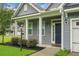 Inviting front entrance with elegant columns, fresh landscaping, and a stylish front door at 504 Foxbank Plantation Blvd, Moncks Corner, SC 29461