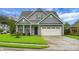 Charming home featuring a well-maintained lawn, two-car garage, and attractive exterior finishes at 504 Foxbank Plantation Blvd, Moncks Corner, SC 29461
