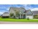 View of home with a well-kept lawn and landscaping, plus a 2 car garage at 504 Foxbank Plantation Blvd, Moncks Corner, SC 29461