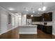 Spacious kitchen features an island, granite countertops, stainless steel appliances, and dark wood cabinets at 504 Foxbank Plantation Blvd, Moncks Corner, SC 29461