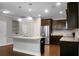 Open concept kitchen with island, granite countertops, stainless steel appliances and dark wood cabinetry at 504 Foxbank Plantation Blvd, Moncks Corner, SC 29461