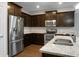 Modern kitchen features stainless steel appliances, granite countertops, and dark wood cabinets at 504 Foxbank Plantation Blvd, Moncks Corner, SC 29461