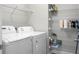 This laundry room boasts a washer, dryer, and ample shelving for organized storage at 504 Foxbank Plantation Blvd, Moncks Corner, SC 29461