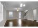 Bright living room with hardwood floors, a staircase, and a ceiling fan at 504 Foxbank Plantation Blvd, Moncks Corner, SC 29461