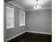 Cozy room featuring dark wood floors, fresh paint, and two windows with blinds at 504 Foxbank Plantation Blvd, Moncks Corner, SC 29461