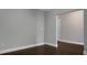 Clean living room showcasing neutral walls, white trim, and beautiful dark wood floors at 504 Foxbank Plantation Blvd, Moncks Corner, SC 29461