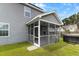 View of a screened in porch attached to a house with gray siding at 504 Foxbank Plantation Blvd, Moncks Corner, SC 29461
