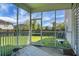 View from the screened-in porch overlooking the large, well-manicured lawn and fenced-in backyard at 504 Foxbank Plantation Blvd, Moncks Corner, SC 29461
