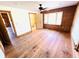 A bright bedroom with hardwood floors, wood paneled accent walls, and a view into the bathroom at 6935 Hickorynut Ln, Ravenel, SC 29470