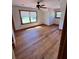Bright bedroom features a ceiling fan and wood floors at 6935 Hickorynut Ln, Ravenel, SC 29470