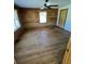 Spacious bedroom featuring wood paneled walls, hardwood floors, and a ceiling fan at 6935 Hickorynut Ln, Ravenel, SC 29470
