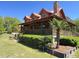Charming log home with a stone chimney, porch, and a wraparound deck offers rustic elegance at 6935 Hickorynut Ln, Ravenel, SC 29470