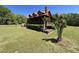 Charming log cabin home with a red metal roof and a covered porch at 6935 Hickorynut Ln, Ravenel, SC 29470