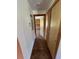 Hallway with wood flooring and storage closet at 6935 Hickorynut Ln, Ravenel, SC 29470
