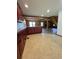 Kitchen area with tile floors, wood cabinets and access to the living room at 6935 Hickorynut Ln, Ravenel, SC 29470