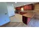 Well-lit kitchen with wood cabinets, tiled floor, and stainless steel appliances at 6935 Hickorynut Ln, Ravenel, SC 29470
