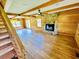Spacious living room features hardwood floors, stone fireplace, wood beams, and bright natural light at 6935 Hickorynut Ln, Ravenel, SC 29470