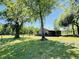 Small barn on lawn with large mature trees at 6935 Hickorynut Ln, Ravenel, SC 29470