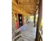 View of covered front porch with a swing and rocking chairs, with access to the living area at 6935 Hickorynut Ln, Ravenel, SC 29470