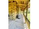 Inviting log cabin porch with wood decking, rustic railings, and a charming barrel accent at 6935 Hickorynut Ln, Ravenel, SC 29470