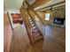 Interior of the house featuring hardwood flooring, stone fireplace, and wooden staircase at 6935 Hickorynut Ln, Ravenel, SC 29470