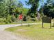Street view with a stop sign and an American flag at 6935 Hickorynut Ln, Ravenel, SC 29470