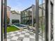 Stylish outdoor living space with a black and white checkerboard tile patio and a modern pool at 70 King St, Charleston, SC 29401