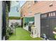 Outdoor kitchen with built-in grill, artificial turf, and privacy fence perfect for gatherings at 70 King St, Charleston, SC 29401