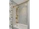 Bathroom featuring modern bathtub with gold shower fixtures and colorful wallpaper at 70 King St, Charleston, SC 29401