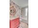 Bright bathroom with patterned wallpaper, pink vanity, and modern fixtures at 70 King St, Charleston, SC 29401