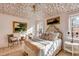 Bright, sunlit bedroom featuring hardwood floors, decoratively-papered ceiling, and luxury linens at 70 King St, Charleston, SC 29401