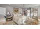 Spacious bedroom with a large bed, ornate side tables, an ensuite bathroom, and natural lighting at 70 King St, Charleston, SC 29401